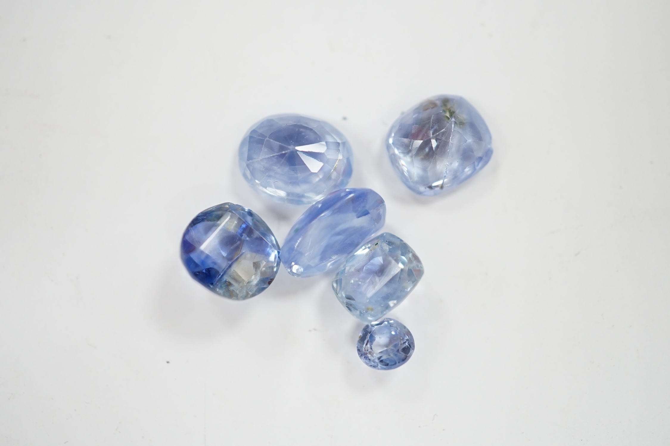 A group of ten cut unmounted pale blue sapphires, total carat weight approximately 15.1ct. Condition - fair